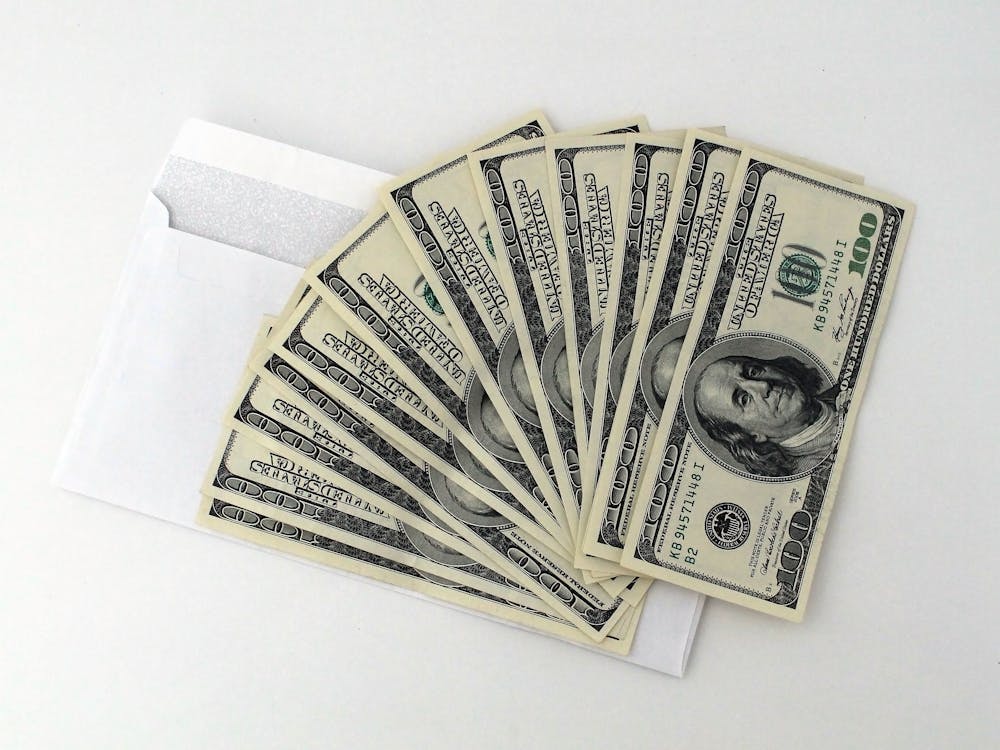 100 US dollar banknotes on a white envelop