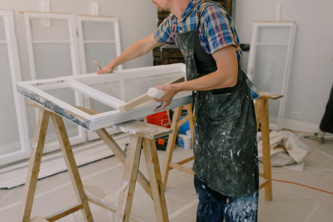 An image of a person working on a window