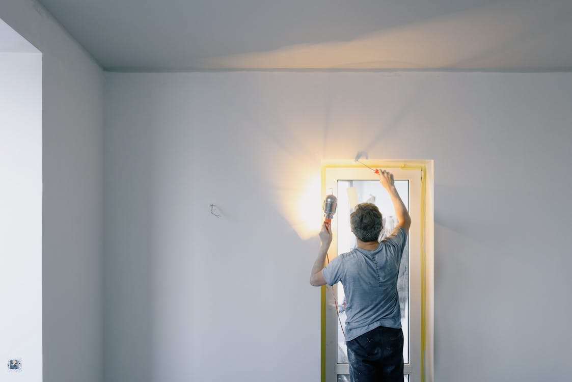 An image of a man renovating a room