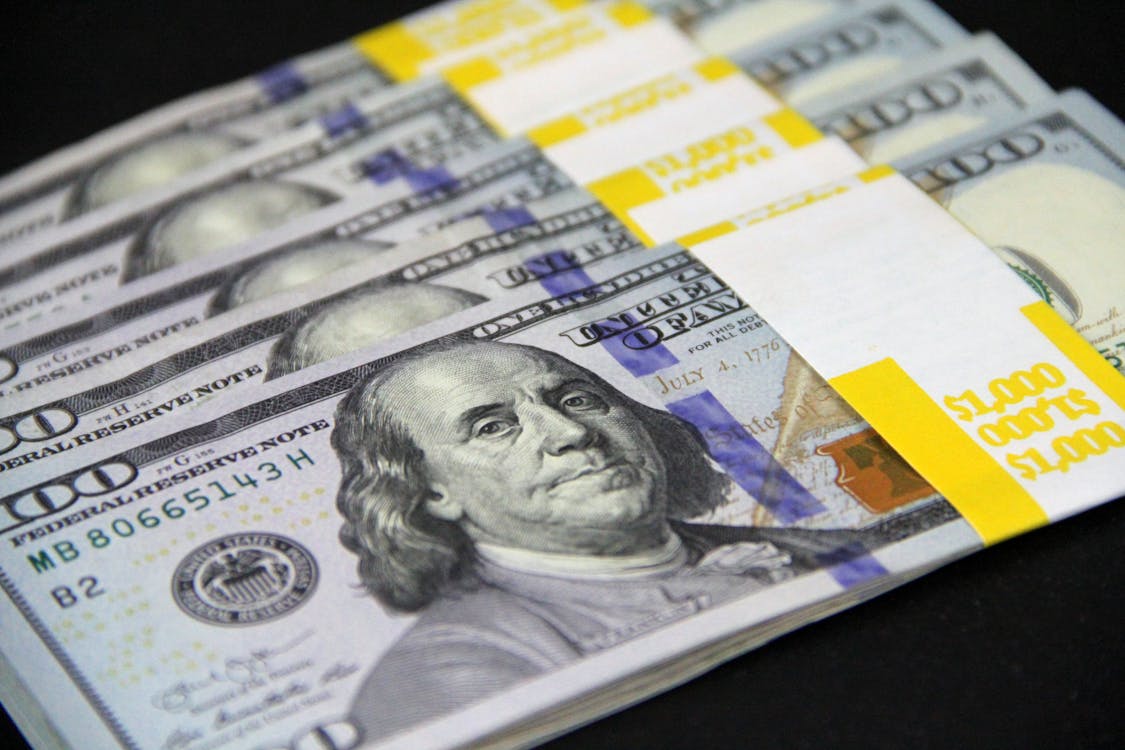 A closeup image of 100 US dollar bundles