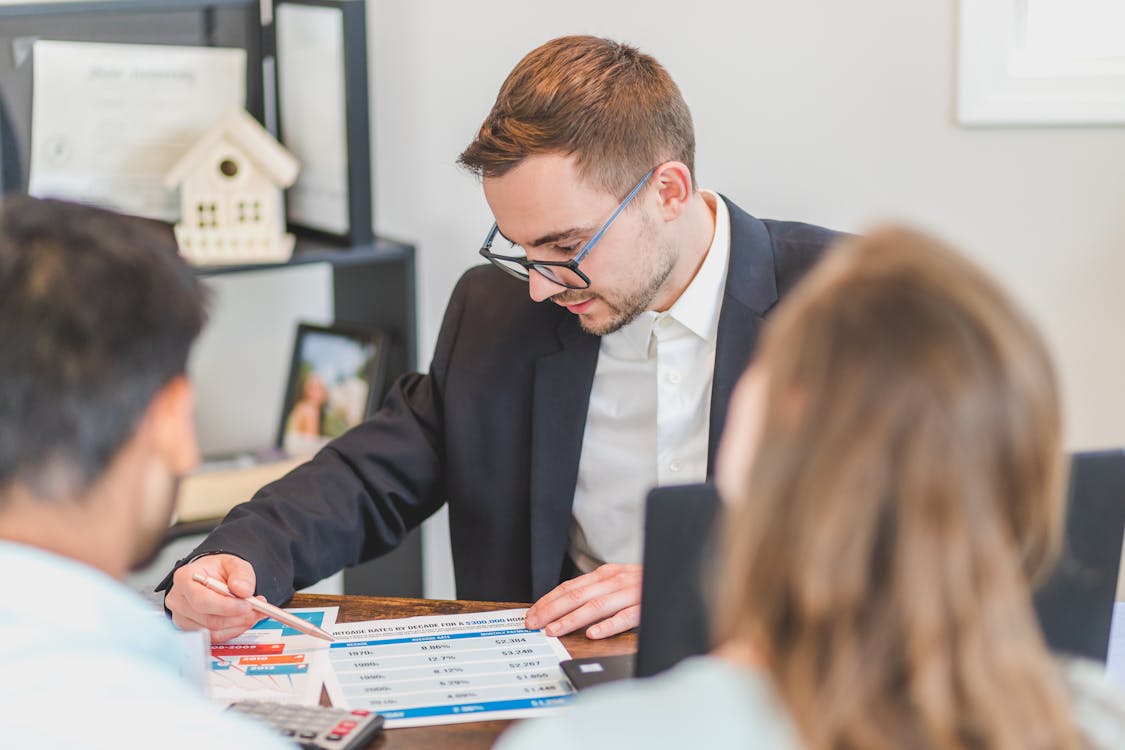 An image of a hard money lender having a discussion with his clients