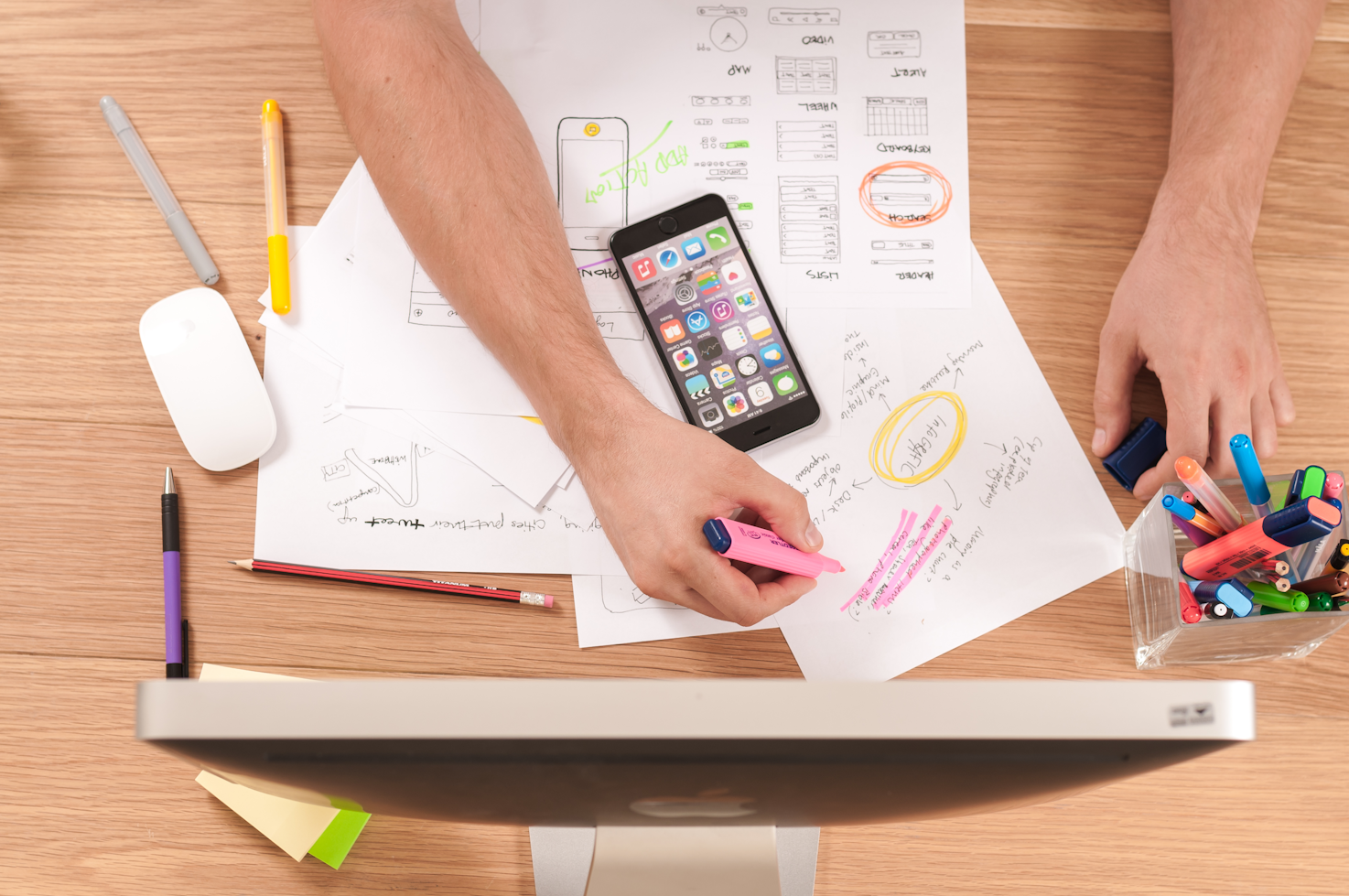 A person working with markers on a real estate business plan