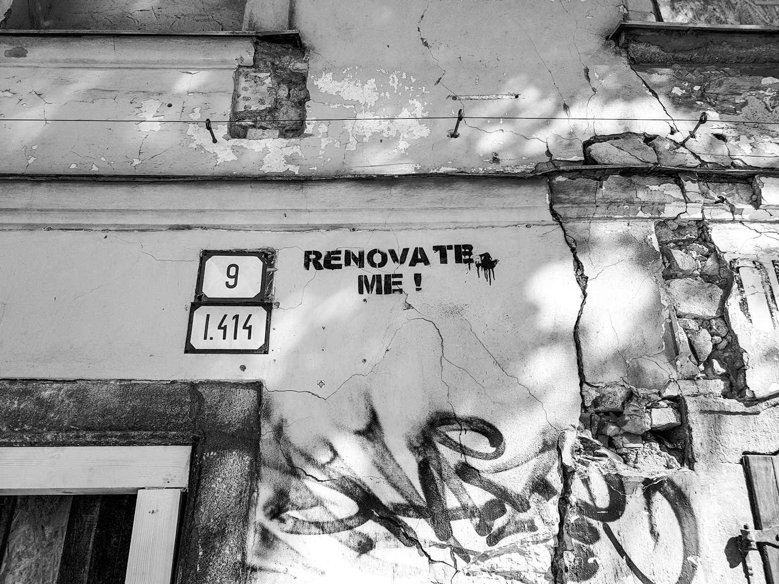 A fix-and-flip property with “renovate me” written on it