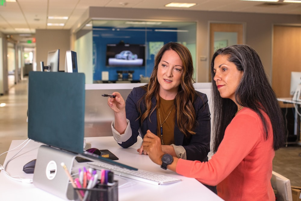  Two women looking at a computer screen.