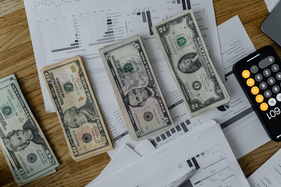 dollar bills neatly displayed on a wooden table