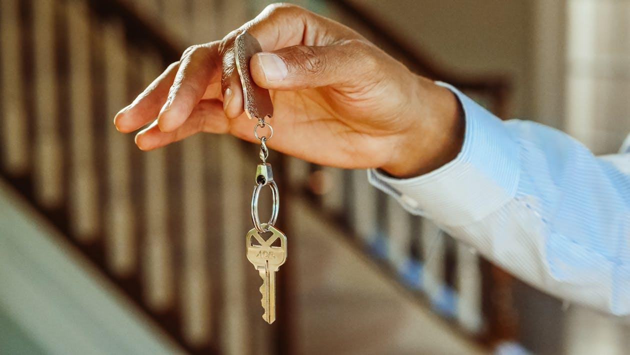 A person holding a house key