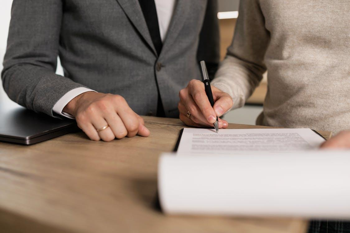 an individual signing a document