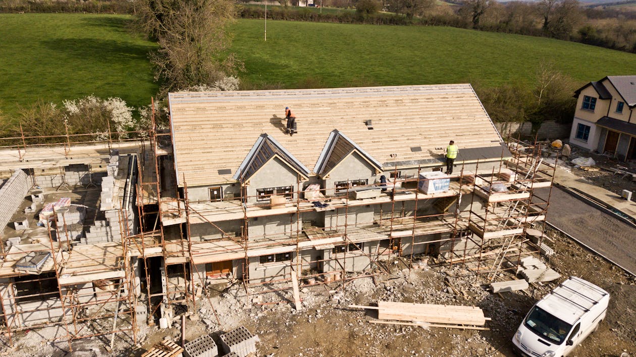 A Home Being Built in South Carolina, Featuring Scaffolding, Construction Waste, and Roofing