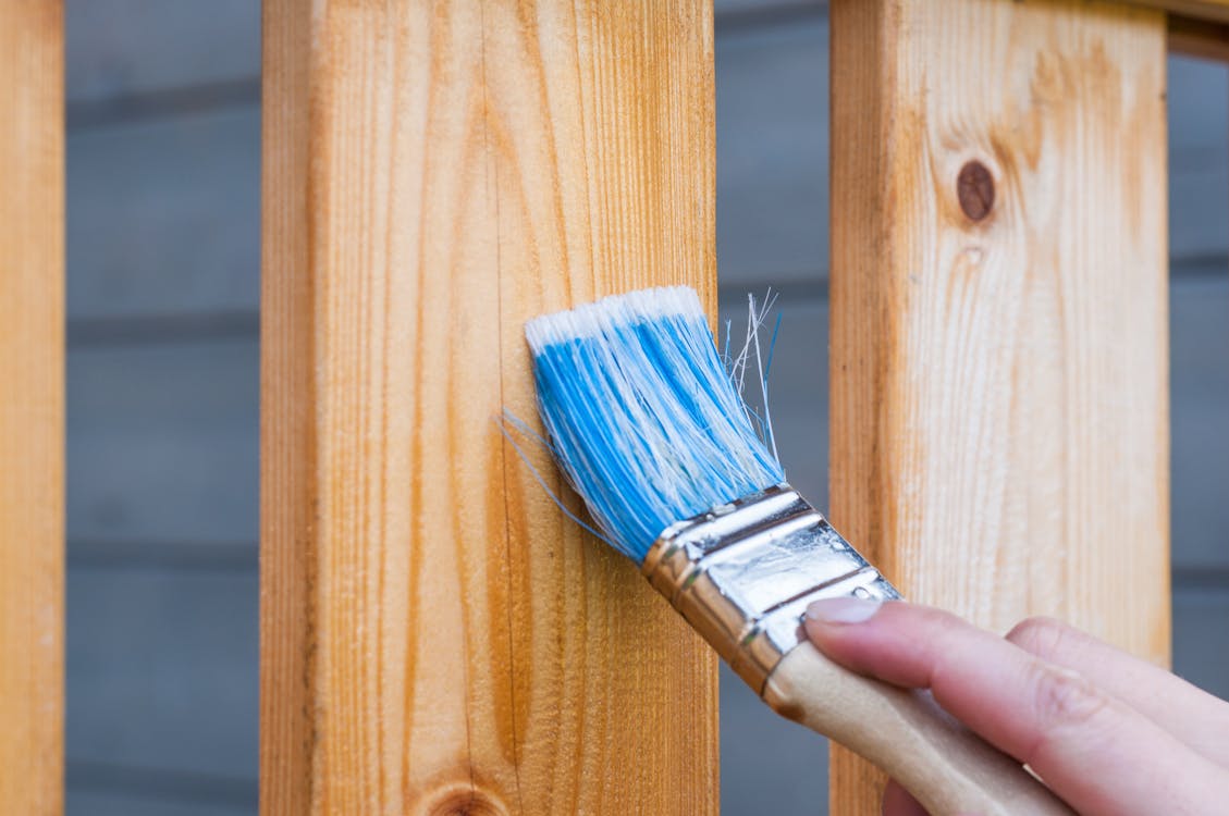 A person finishing a wood panel